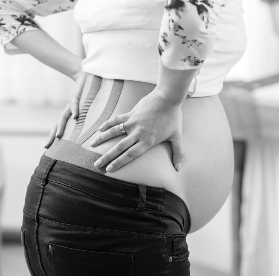 Pregnant woman wearing Kinesio-Tape against back pain