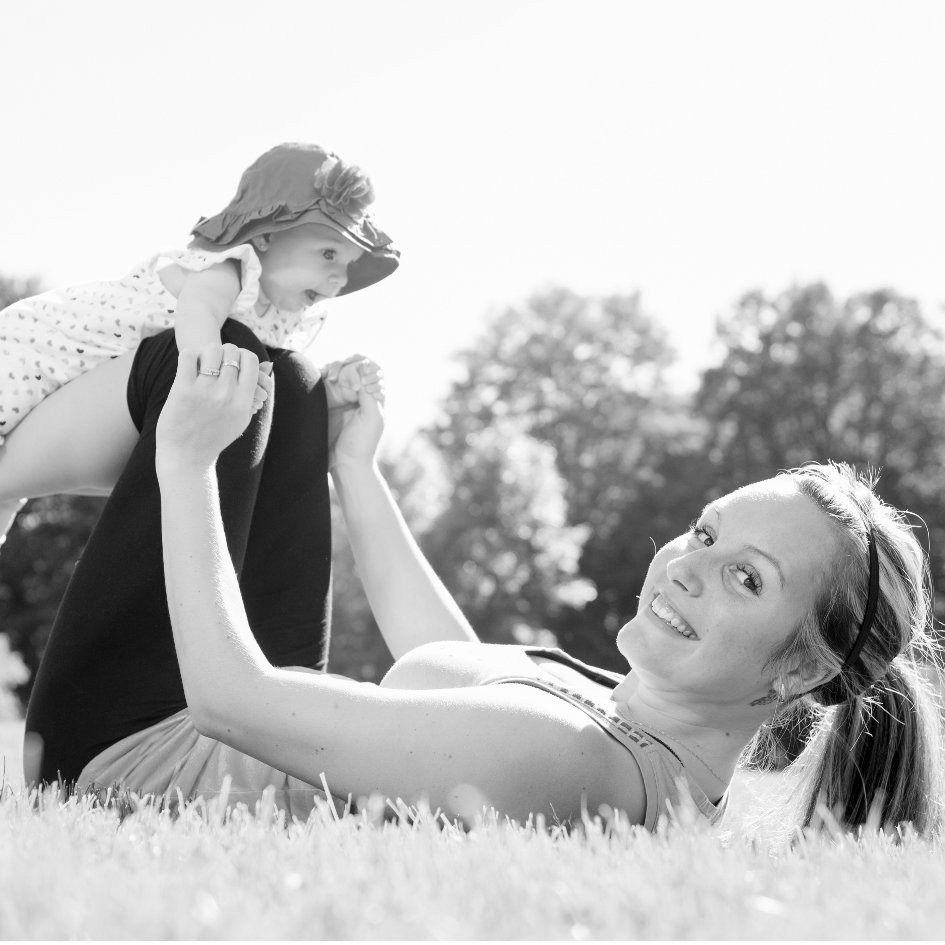 A mother training with baby on a summer day